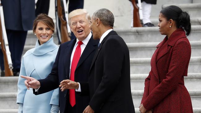 President Donald Trump and first lady Melania Trump talk with former President Barack Obama and Michelle Obama during a departure ceremony. Picture: AP
