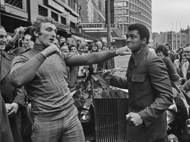 Joe Bugner playfully spars with Muhammad Ali outside the Dominion Theatre on Tottenham Court Rd in London in 1974. Picture: Getty