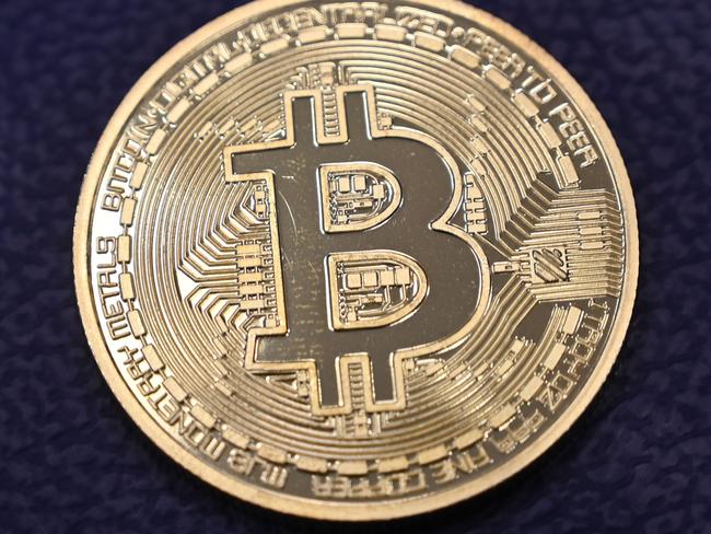 This photograph taken on December 17, 2020 shows shows a physical imitation of a Bitcoin at a crypto currency "Bitcoin Change" shop, near Grand Bazaar, in Istanbul. - Leading virtual currency bitcoin on 16 December traded above $20,000 for the first time following a sustained run higher in recent weeks. Bitcoin reached a record-high $20,398.50 before pulling back to $20,145, which was still an intra-day gain of nearly four percent. (Photo by Ozan KOSE / AFP)