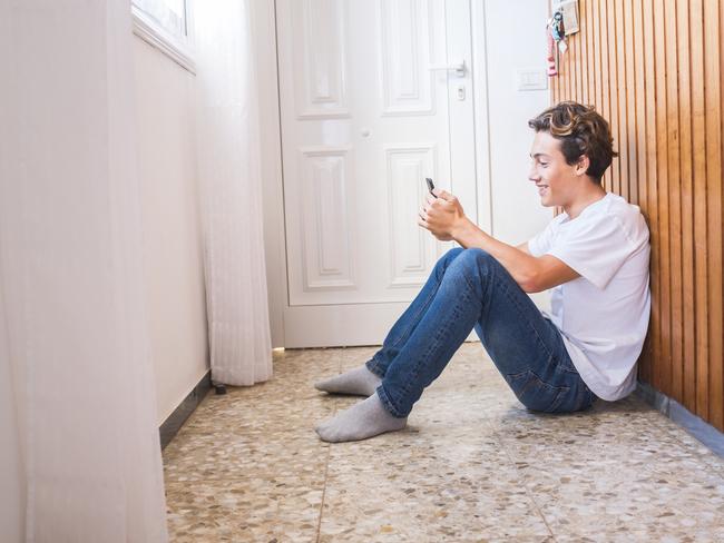 Stay home lockdown quarantine for coronavirus health worldwide emergency covid-19 pandemic epidemic situation concept with young teenager sit down on the floor near the door waiting to go out