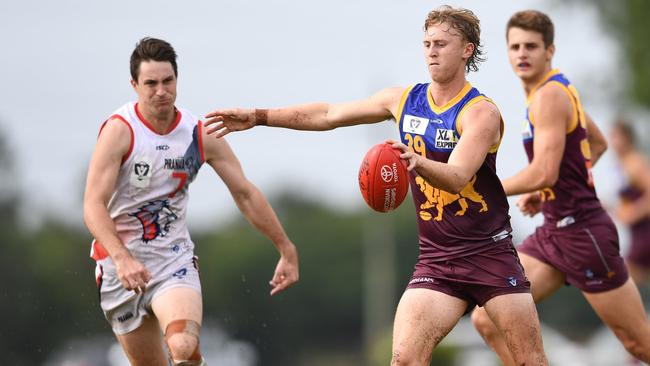 Carter Michael looks to kick long in muddy conditions while playing for the Brisbane Lions in the VFL. Picture: Highflyer Images