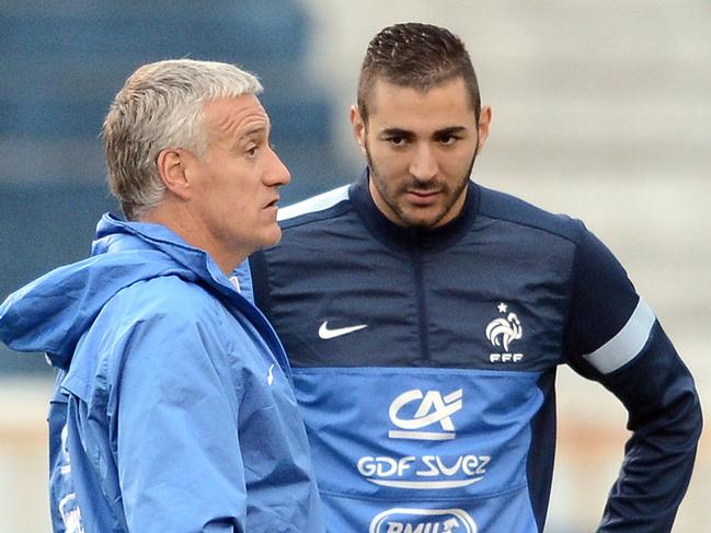 This photo taken in 2013 shows French national football team's head coach Didier Deschamps (L) speaking next to sidelined forward Karim Benzema.