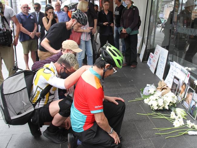 Delivery workers and the Transport Workers Union hold a vigil outside Uber's Sydney office after the deaths of five delivery riders in two months.