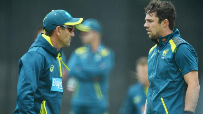 Australia coach Justin Langer talks to Travis Head at a training session in Adelaide in preparation for tomorrow’s ODI against South Africa. Picture: AAP