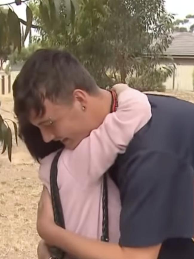 Mother of the victim Gay Hales hugs hero Sean Williams, after pulling mother-of-three Marilyn Hales from her burning house. Picture: 7NEWS