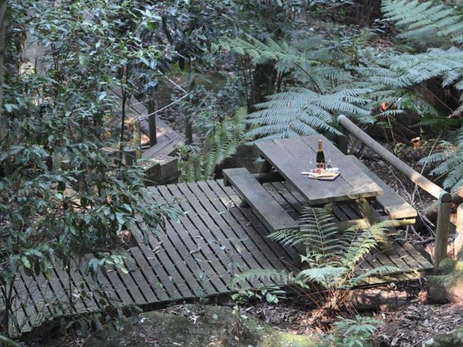 Picnic tables are dotted along the walking tracks to take a break if you need. Picture: Waterfall Springs Retreat/Booking.com