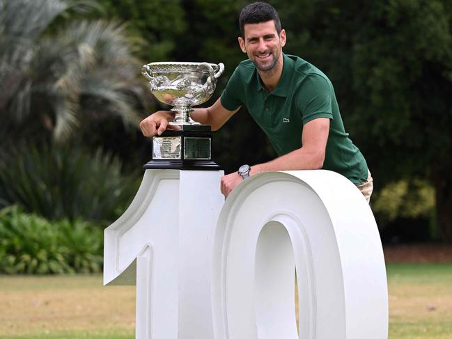 Serbia's Novak Djokovic poses with the Norman Brookes Challenge Cup trophy in Melbourne on January 30, 2023, after winning the Australian Open tennis tournament's mens' singles final against Greece's Stefanos Tsitsipas. (Photo by WILLIAM WEST / AFP) / -- IMAGE RESTRICTED TO EDITORIAL USE - STRICTLY NO COMMERCIAL USE --