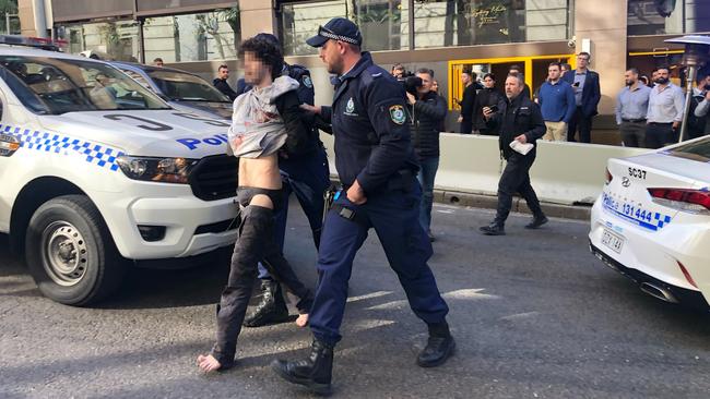 NSW police take the alleged attacker into custody in Sydney’s CBD.