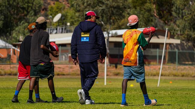 Melbourne Demons players Shane McAdam and Andy Moniz-Wakefield went to Santa Teresa ahead of the 2025 AFL game in Alice Springs. Picture: Melbourne Demons