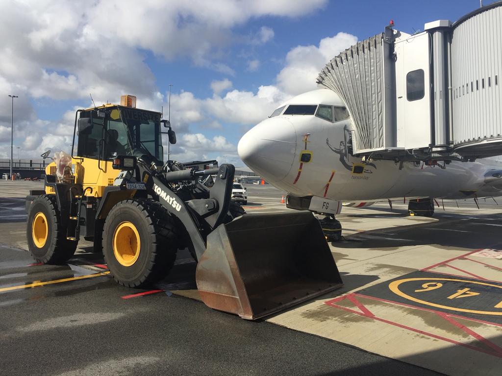 Another aircraft, a Virgin Australia Boeing 737-800, which is being blocked by an airport bulldozer. Picture: Geoffrey Thomas