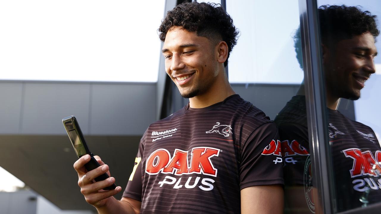 DAILY TELEGRAPH SEPTEMBER 27, 2022. Panthers player Izack Tago with his flip phone during a media session at the Panthers Rugby League Academy. Picture: Jonathan Ng