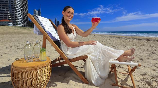 **HOLD FOR FUTURE BRISBANE: DAY 1 FRONT PAGE**Jessica Sims with Yuri Ketsuriyong (waitress) enjoys the beachfront at the Langham on the Gold Coast. Pics Adam HeadStory: Mediterranean-style beach clubs could become permanent summer fixtures on Queensland famous beaches. While overwater helipads and more water taxi-style services on the Brisbane River could unlock faster commuter travel to popular precincts and the Moreton Bay Islands, as city leaders work to unlock the potential of the southeastÃs signature waterfronts for the betterment of both tourists and locals.