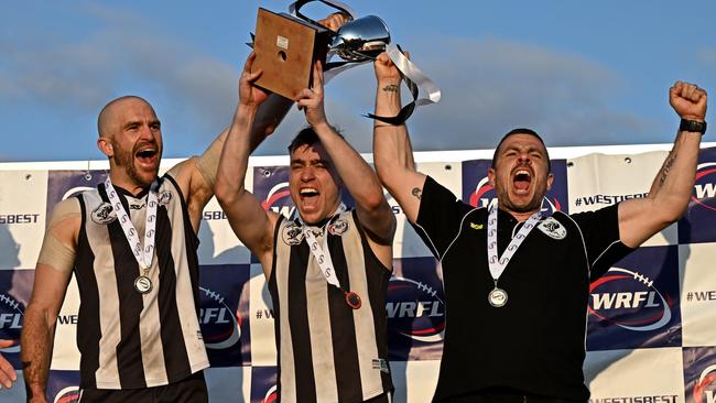 Co-captains Shaun Campbell, Jackson Barrett and coach Chris Muratore celebrate Parkside’s premiership win. Picture: Andy Brownbill