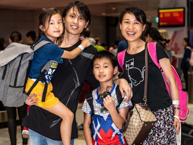 Shan, Rui, Zoe &amp; Tianshu Li are reunited at Sydney airport after being held in quarantine in Darwin. Picture: Monique Harmer