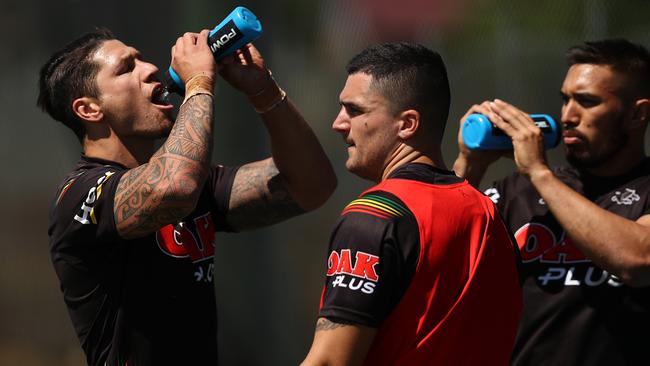 Penrith's Malakai Watene-Zelezniak (left) hydrates in the heat. Picture: Brett Costello