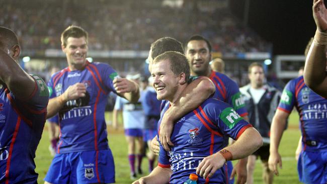 Halfback Scott Dureau (centre) celebrates kicking a winning field goal in golden point extra time for the Newcastle Knights.