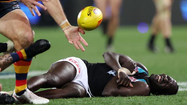 Aliir Aliir goes down after a heavy collision with teammate Lachie Jones. Picture: Getty