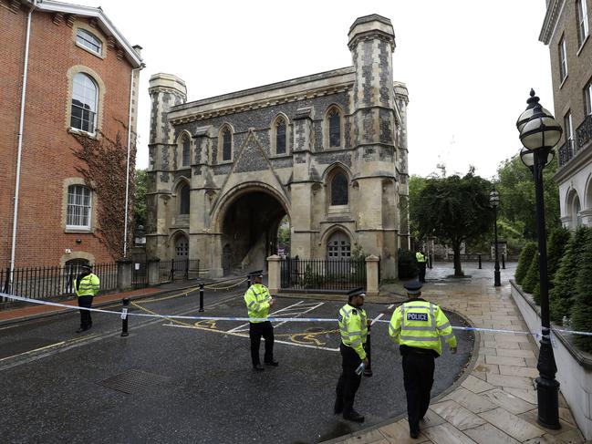 Police stand guard at the Abbey gateway of Forbury Gardens park in Reading town centre following Saturday’s stabbing attack in the gardens. Picture: Jonathan Brady/PA via AP