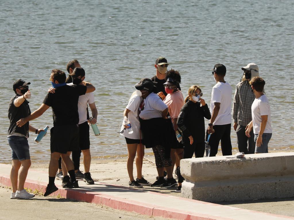 Cast members from the TV Show Glee and friends comfort each other as they gathered at Lake Piru boat launch Monday morning just as Ventura County Sheriffs Search and Rescue dive team located Rivera.. Picture: Al Seib/Los Angeles Times via Getty Images