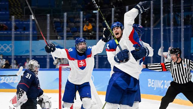 Slovakia's Marek Hrivik (right) celebrates with teammates after scoring a goal during the men's playoff quarter-final against the USA. Picture: AFP