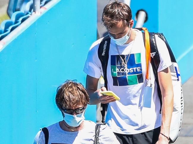 Coach Gilles Cervara, left, and Daniil Medvedev of Russia arrive for a training session at Melbourne Park. Picture: Getty Images