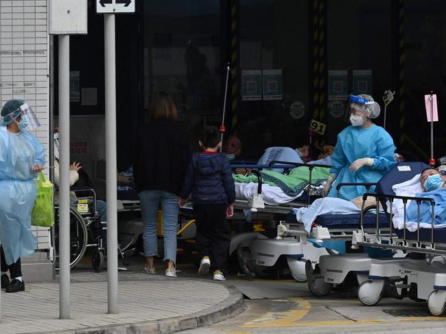 People lie in hospital beds outside the Caritas Medical Centre in Hong Kong as the city faces its worst Covid-19 coronavirus wave to date. Picture: AFP