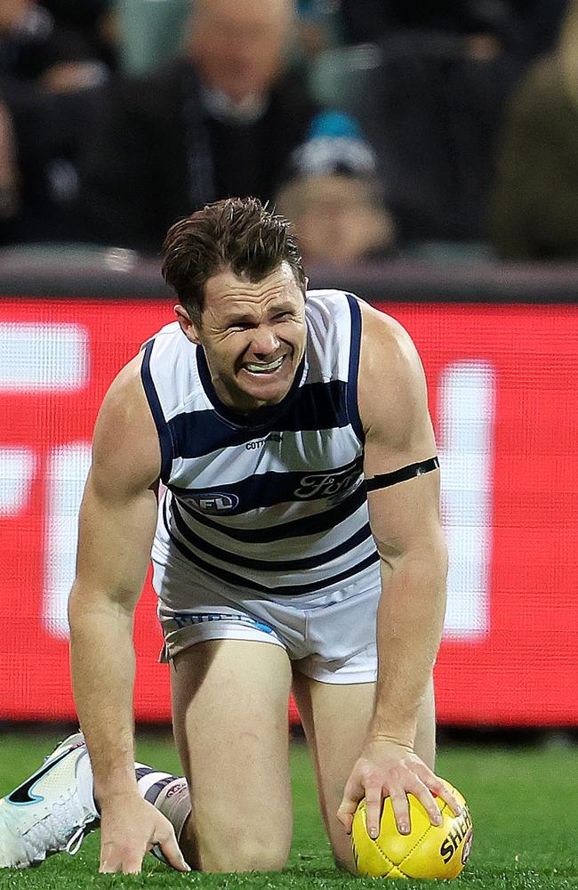 Patrick Dangerfield winces after being hit against Port Adelaide. Picture: Sarah Reed/AFL Photos via Getty Images