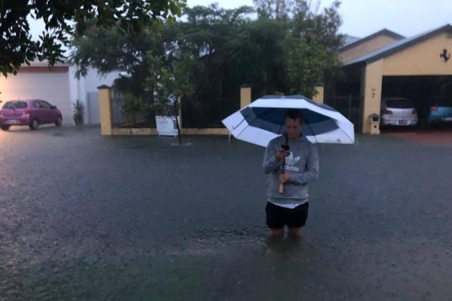 David Bark’s picture of his 6’1 son in a flooded Biggera Waters street. 