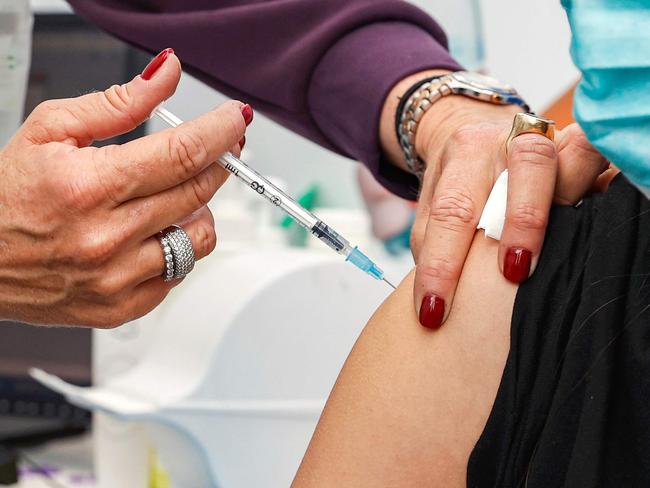 Leehee, an 18-year-old teenager, receives a dose of the Pfizer-BioNtech COVID-19 coronavirus vaccine at Clalit Health Services, in Israel's Mediterranean coastal city of Tel Aviv on January 23, 2021. - Israel began administering novel coronavirus vaccines to teenagers as it pushed ahead with its inoculation drive, with a quarter of the population now vaccinated, health officials said. (Photo by JACK GUEZ / AFP)
