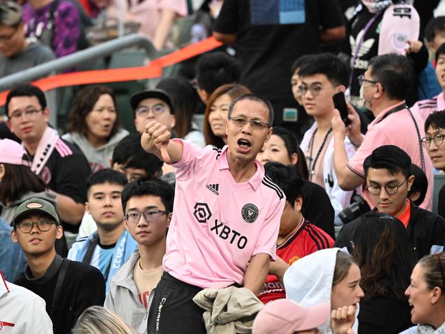 Fans react after not seeing Inter Miami's Argentine forward Lionel Messi play after the friendly football match between Hong Kong XI and US Inter Miami CF in Hong Kong on February 4, 2024. Inter Miami were booed off the pitch after their injured superstar Lionel Messi failed to take the field in a pre-season friendly in Hong Kong. (Photo by Peter PARKS / AFP)