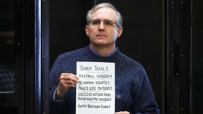 Former U.S. Marine Paul Whelan, who was detained and accused of espionage, held a sign during his 2020 verdict hearing in Moscow. Picture: Getty