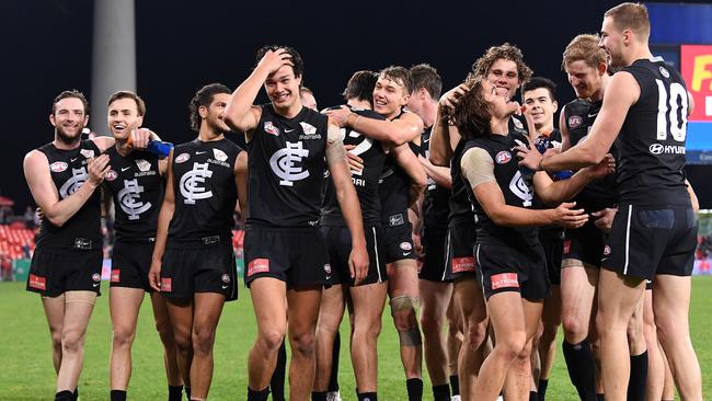 Blues players celebrate as they walk off the field folllowing the Round 19 AFL match between the Gold Coast Suns and the Carlton Blues at Metricon Stadium at Carrara on the Gold Coast, Saturday, July 28, 2018. (AAP Image/Dave Hunt) NO ARCHIVING, EDITORIAL USE ONLY