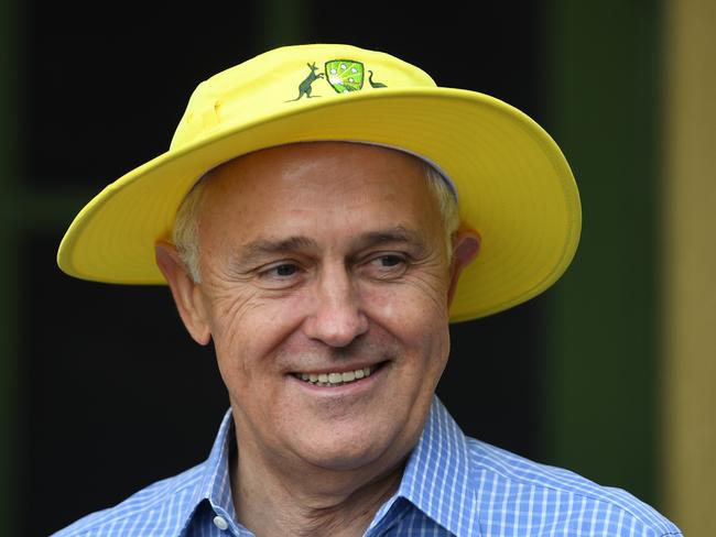 Australian Prime Minister Malcolm Turnbull wears a yellow cricket hat as he receives members of the Australian Women's Cricket Ashes team during a breakfast event at the Lodge in Canberra, Wednesday, November 22, 2017. (AAP Image/Lukas Coch) NO ARCHIVING