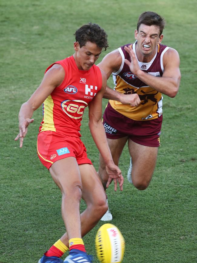 Suns youngster Wil Powell kicks under pressure. Picture: Getty Images