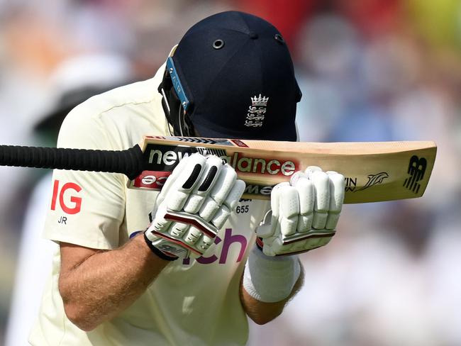 England's captain Joe Root reacts as he walks back to the pavilion after losing his wicket during play on the fifth day. (Photo by Glyn KIRK / AFP)