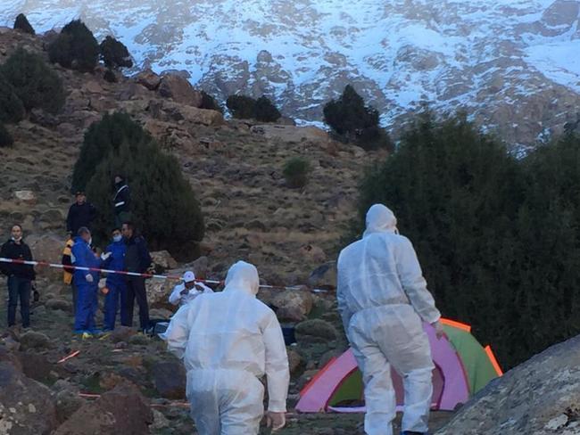 Forensic officers hike up to the crime scene in the High Atlas Mountains. Picture: 2M via AP