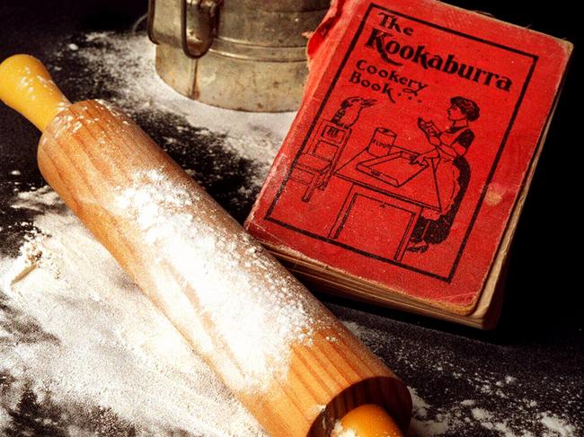 Kookaburra Cookery Book recipe cook book next to rolling pin and flour sifter. /Books