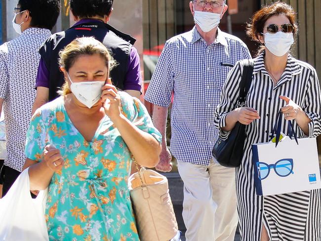 SYDNEY, AUSTRALIA - NewsWire Photos JANUARY, 11, 2021: People seen wearing face masks while walking through the central shopping district of Chatswood inline with the new rules on mandatory mask wearing for Covid-19 in Sydney, Australia. Picture: NCA NewsWire / Gaye Gerard