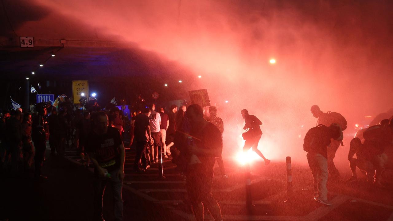 Israeli left-wing protesters are sprayed with water cannon during clashes with security forces on the sidelines of an anti-government demonstration in Tel Aviv. Picture: AFP