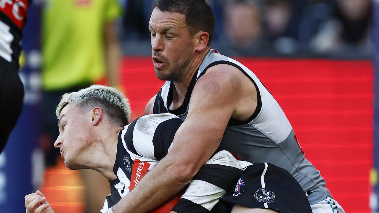 Travis Boak tackles Magpie Jack Ginnivan. Picture: Daniel Pockett/Getty Images