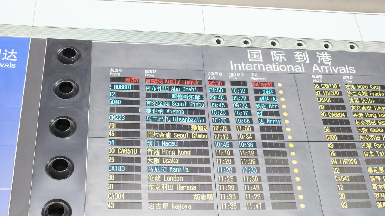 An international arrivals board shows Malaysia Airlines Flight MH370 as being delayed at Beijing International Airport March 8, 2014. Picture: Xiao Lu Chu/Getty Images