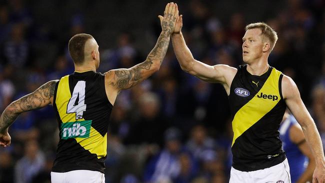 Dustin Martin and Jack Riewoldt celebrate a goal.