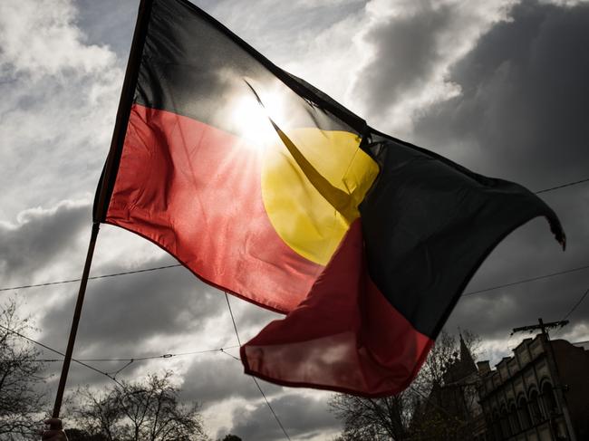 MELBOURNE, AUSTRALIA - JULY 07: The Aboriginal flag is seen flying during the NAIDOC March on July 07, 2023 in Melbourne, Australia. NAIDOC Week is an Australian observance lasting from the first Sunday in July until the following Sunday. The acronym NAIDOC stands for National Aborigines and Islanders Day Observance Committee. The week is intended as a time when all Australians can reflect on the rich history of the country's indigenous peoples, and learn about the cultures and histories of first nations groups. (Photo by Darrian Traynor/Getty Images)