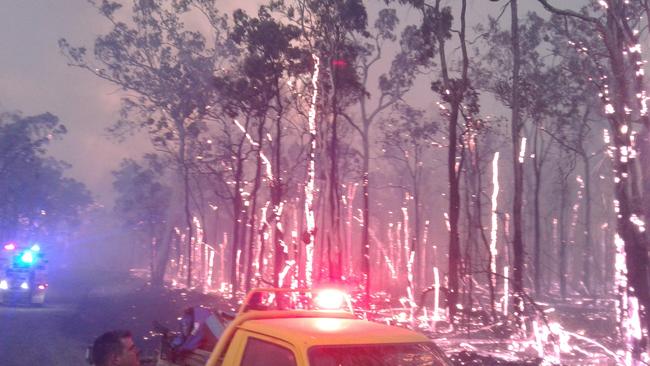 Cawarral Rural Fire Brigade member Nathan Jung keeps an eye on the Cobraball bushfires, burning in the early stages near Old Byfield Road.