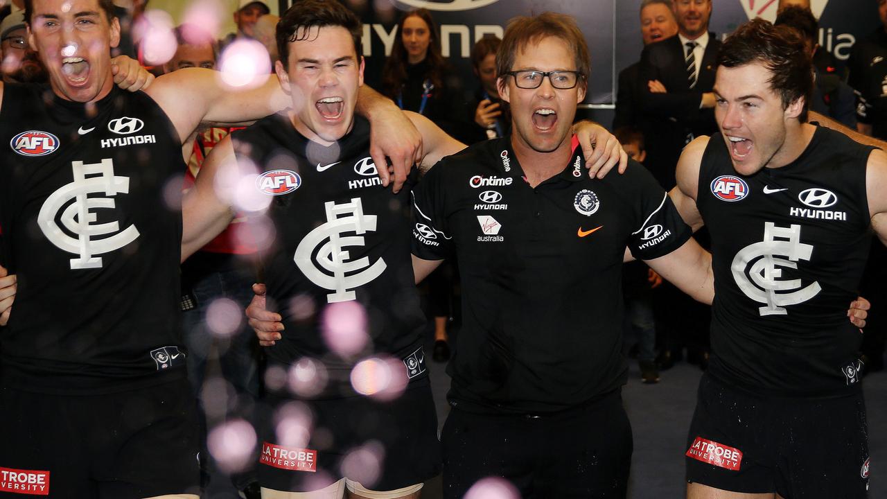 Carlton players celebrate their first win under David Teague last season.