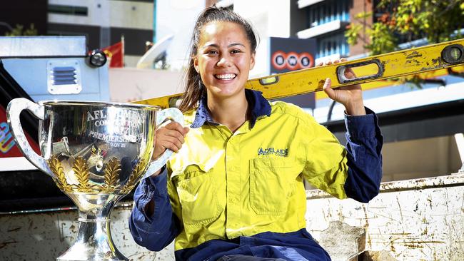 Justine Mules swaps the premiership trophy for tools as she heads back to work. Picture Sarah Reed