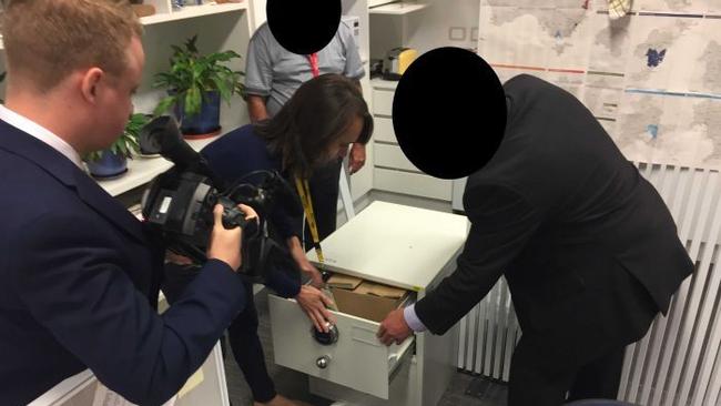 ASIO agents raid the ABC office.