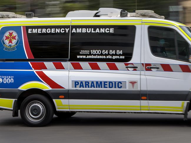 MELBOURNE, AUSTRALIA - NewsWire Photos FEBRUARY 13, 2022: An ambulance speeds away from the Royal Melbourne Hospital. Ambulance, Generic.Picture: NCA NewsWire / David Geraghty