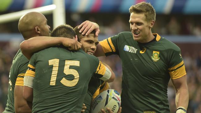 South Africa's wing JP Pietersen (L), South Africa's full-back Willie le Roux (2L) and South Africa's centre and captain Jean de Villiers (R) congratulate South Africa's wing Bryan Habana after he scored his team's final try of the Pool B match of the 2015 Rugby World Cup between South Africa and Samoa at Villa Park in Birmingham, central England, on September 26, 2015. AFP PHOTO / LIONEL BONAVENTURE RESTRICTED TO EDITORIAL USE, NO USE IN LIVE MATCH TRACKING SERVICES, TO BE USED AS NON-SEQUENTIAL STILLS