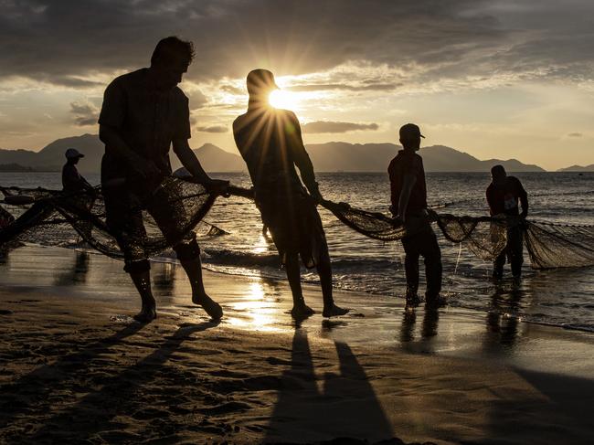 A group of fishermen pull fishing nets at Gampong Jawa beach ahead of the anniversary of the 2004 earthquake and tsunami in Banda Aceh. Picture: AFP/Getty Images